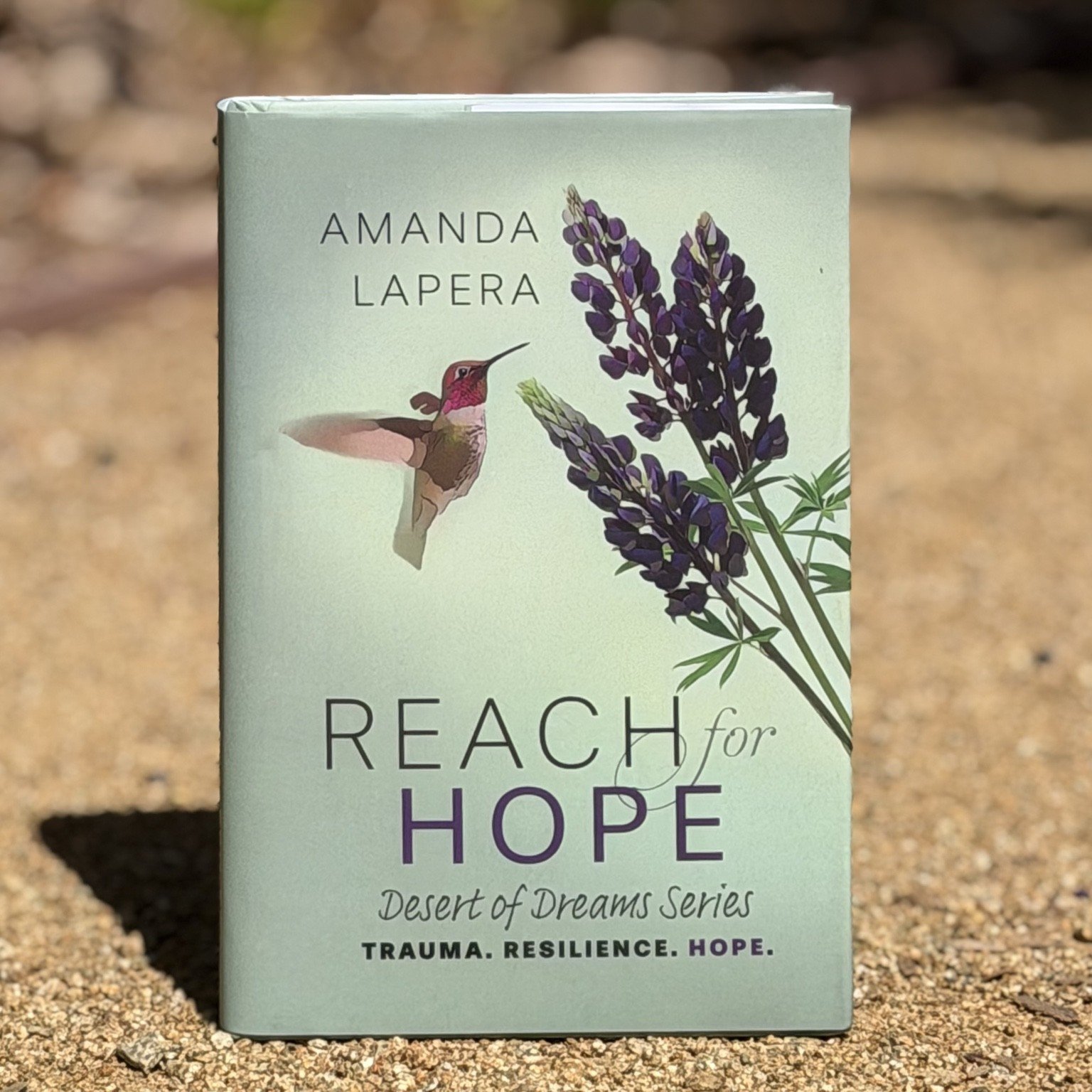 Reach for Hope posed on dirt.